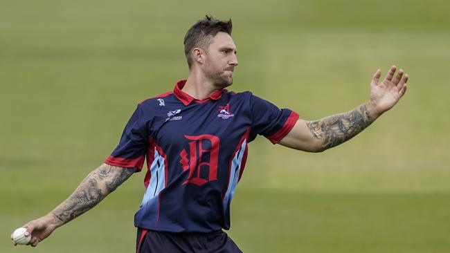 Adam McMaster bowling for Dandenong last season.