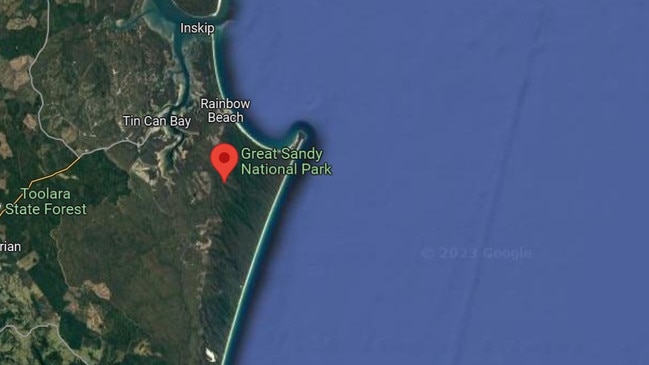 The man, in his 20s, was swimming off the coast of the Great Sandy National Park when he became caught in a rip and was only saved by a nearby surfer. Picture: Google Maps