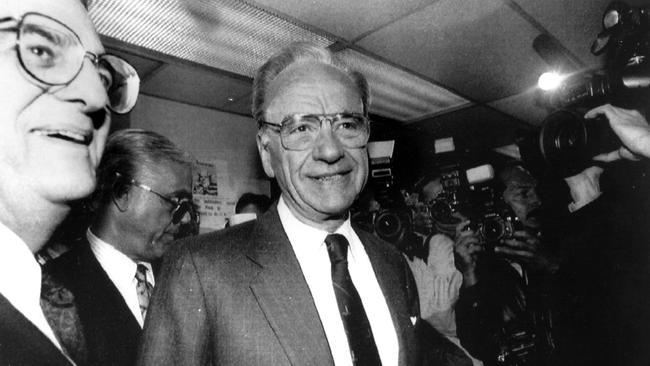 Australian media magnate Rupert Murdoch is mobbed by reporters as he enters the newsroom at the New York Post in New York, on March 29, 1993. A bankruptcy judge granted Murdoch temporary control of the troubled tabloid earlier in the day. Picture: Reuters