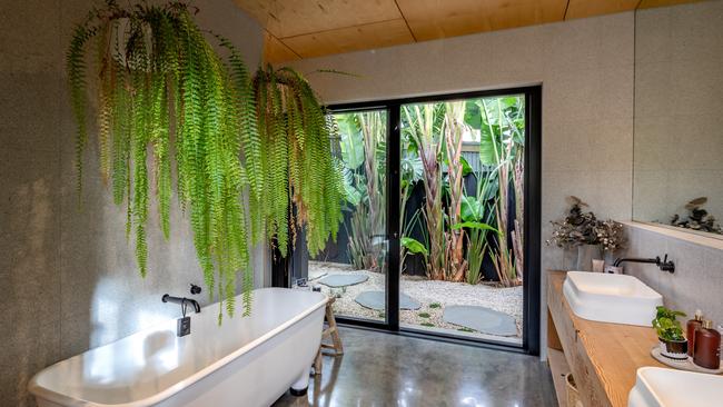 The bathroom brings in the greenery.