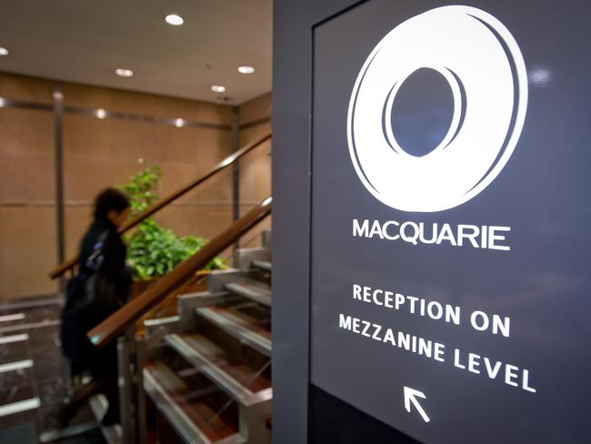 A woman walks past the Macquarie Group Ltd. logo displayed at the company's headquarters in Sydney, Australia, on Thursday, July 28, 2011. Macquarie Group Ltd., Australia's biggest investment bank, is sticking to its forecast that full-year earnings will improve as long as markets don't worsen. Photographer: Ian Waldie/Bloomberg