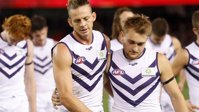 A dejected Nat Fyfe (left) and Mitch Crowden after poor kicking cost Fremantle.