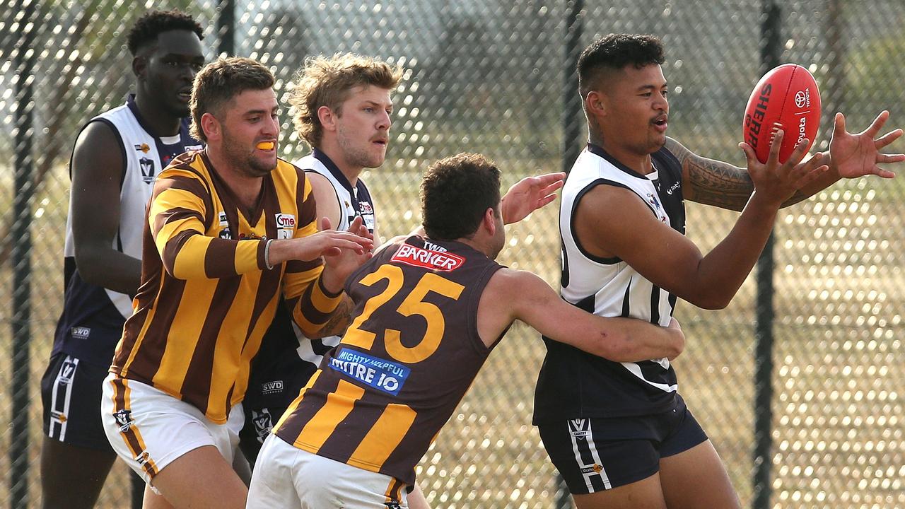 RDFL: Melton Central’s Justin Aiulu is tackled by Josh Pound of Woodend-Hesket. Picture: Hamish Blair