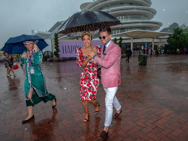 Punters arrive in the rain at Flemington. Picture: Jason Edwards