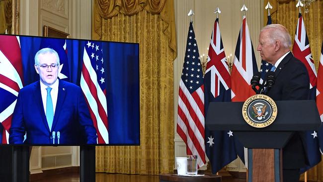 US President Joe Biden speaks on national security with British Prime Minister Boris Johnson (out of frame) and Australian Prime Minister Scott Morrison (R) in East Room of the White House in Washington, DC, on September 15, 2021. (Photo by Brendan Smialowski / AFP)