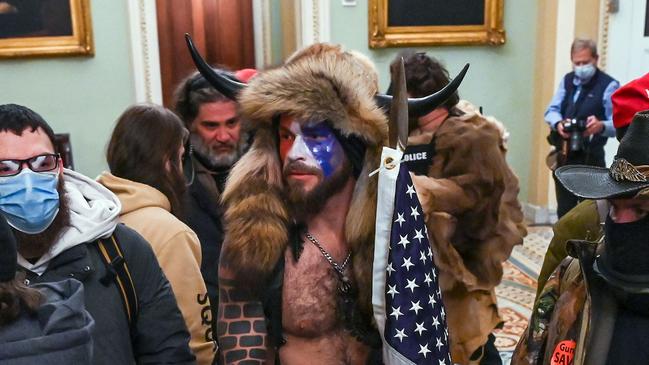 Jacob Anthony Chansley, centre, also known as Jake Angeli, a QAnon supporter who entered the Capitol with rioters last week. Picture: Saul Loeb/AFP