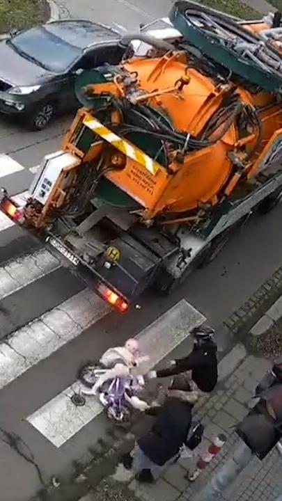 Shocking moment child hit by truck after riding bike into traffic