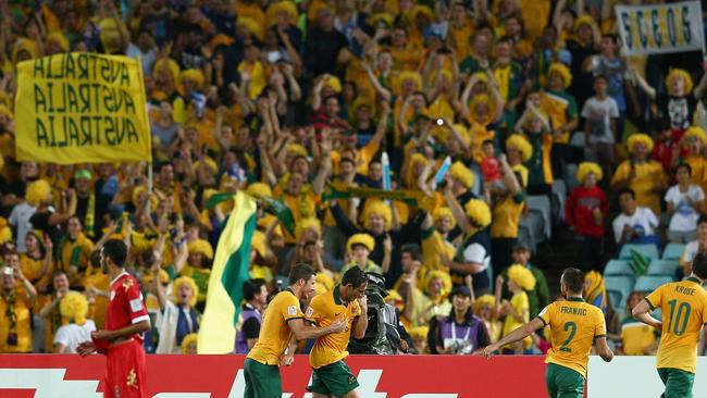 SYDNEY, AUSTRALIA - JANUARY 13: Mark Milligan of the Socceroos celebrates scoring a penalty goal during the 2015 Asian Cup match between Oman and Australia at ANZ Stadium on January 13, 2015 in Sydney, Australia. (Photo by Cameron Spencer/Getty Images)