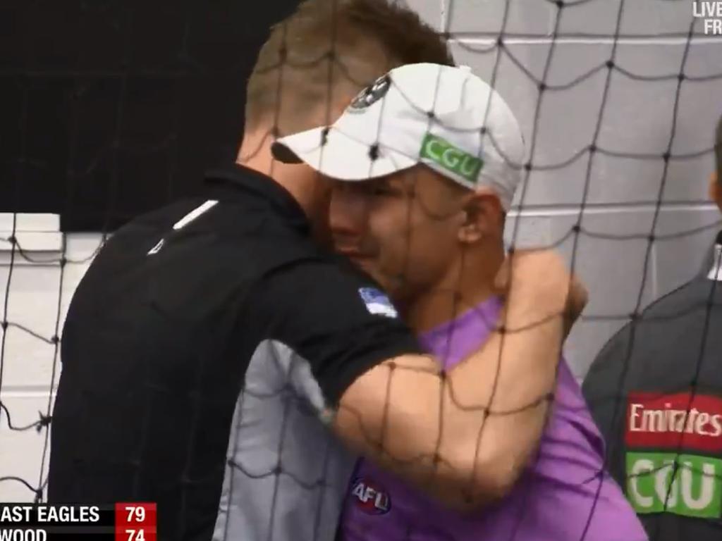 Nathan Buckley hugs Alex Woodward.