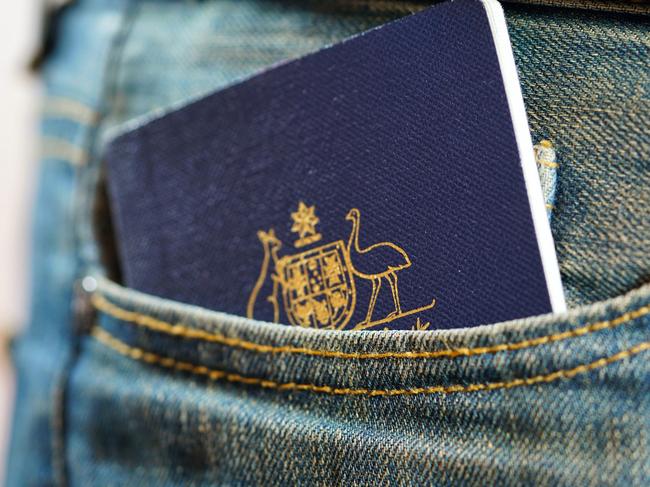 ESCAPE, TRAVEL WISDOM, passport careAustralian passport in mans jeans pocket, close up.