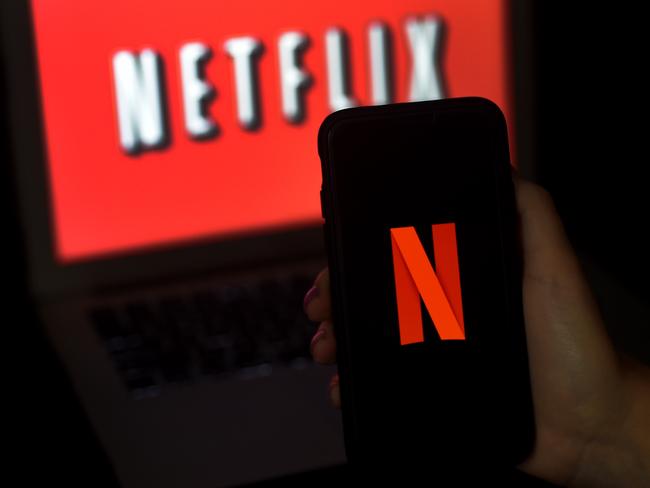 In this photo illustration a computer screen and mobile phone display the Netflix logo on March 31, 2020 in Arlington, Virginia. (Photo by Olivier DOULIERY / AFP)