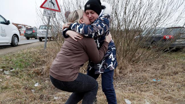 Anna Semyuk, 33, hugs her son at the Beregsurany border crossing, Hungary on February 26, 2022. Picture: Reuters/Bernadett Szabo