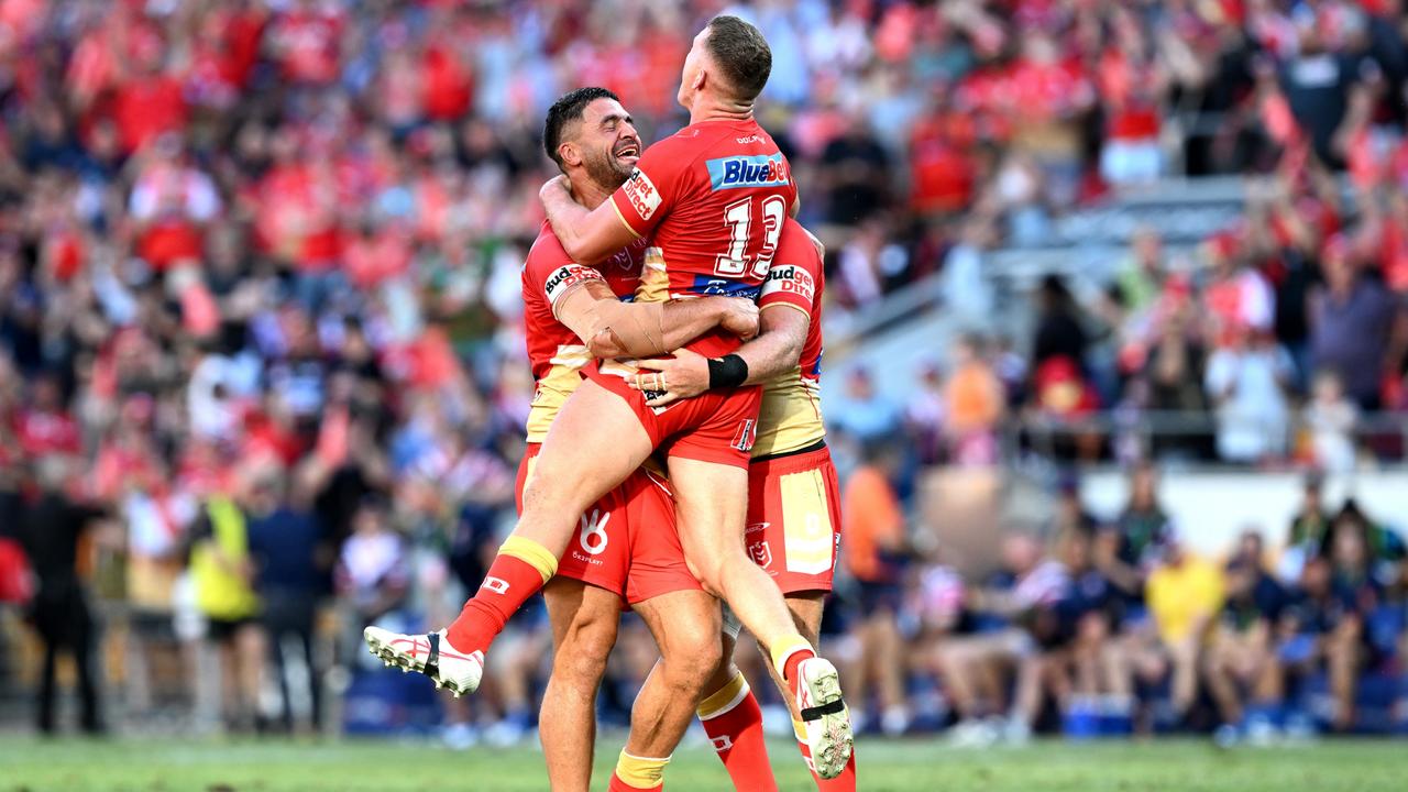 BRISBANE, AUSTRALIA - MARCH 05: Jesse Bromwich, Tom Gilbert and Brenko Lee of the Dolphins celebrate the Dolphins first ever victory in the NRL after the round one NRL match between the Dolphins and Sydney Roosters at Suncorp Stadium on March 05, 2023 in Brisbane, Australia. (Photo by Bradley Kanaris/Getty Images)