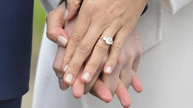 Meghan Markle wears her engagement ring as she poses with Prince Harry for the media in the grounds of Kensington Palace this morning.