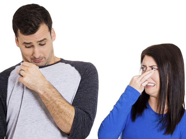 RendezView. Closeup portrait of woman looking at man closing, covering nose, something stinks, very bad smell, odor. Guy sniffs himself. Isolated on white background. Negative emotion, facial expression, feeling.