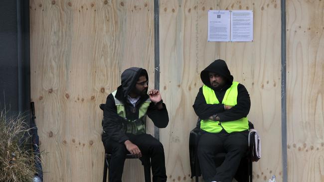 Security guards are seen below an evacuation notices at the Mascot Towers on Thursday, June 20, 2019. Picture: AAP Image/Danny Casey