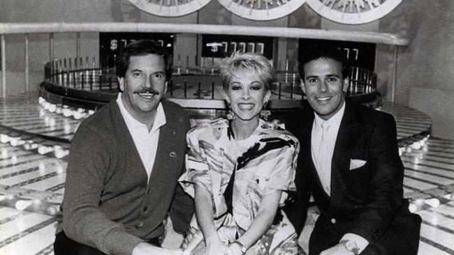 John Burgess, Adriana Xenides, and John Deeks on the Wheel of Fortune set in 1989.