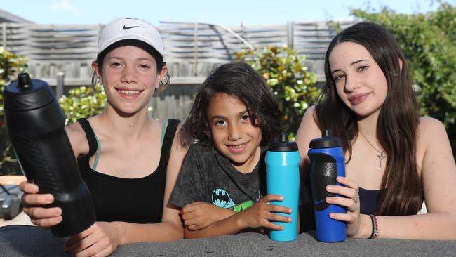 Iluka, Diwana and Jamaiyah recycle their drink bottles. Kit Kline has handy tips and tricks for her fellow parents to save this back to school season. Picture: Alan Barber