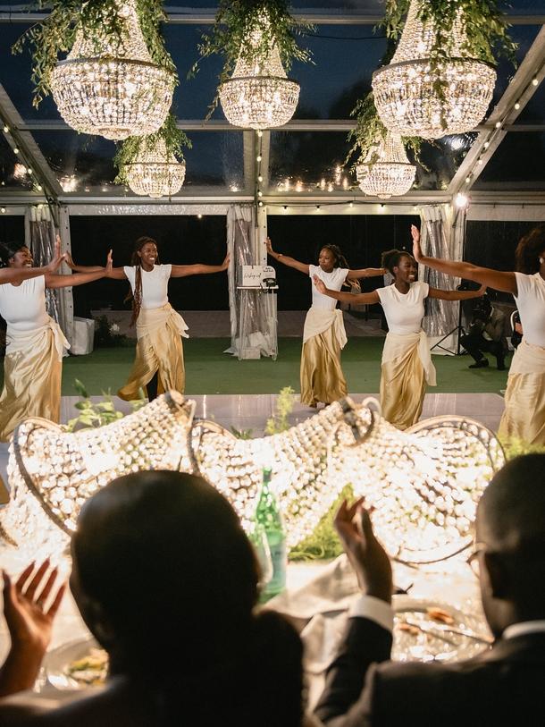 Emmanuel and Florence Ngabo at their wedding watching traditional dancers. Picture: Alexi Patsianis Photography