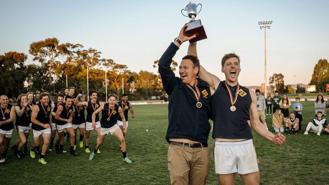 Scotch Old Collegians coach Kym Cobb and captain Lachlan Giles hold the trophy after winning the final. Picture: AAP / Morgan Sette