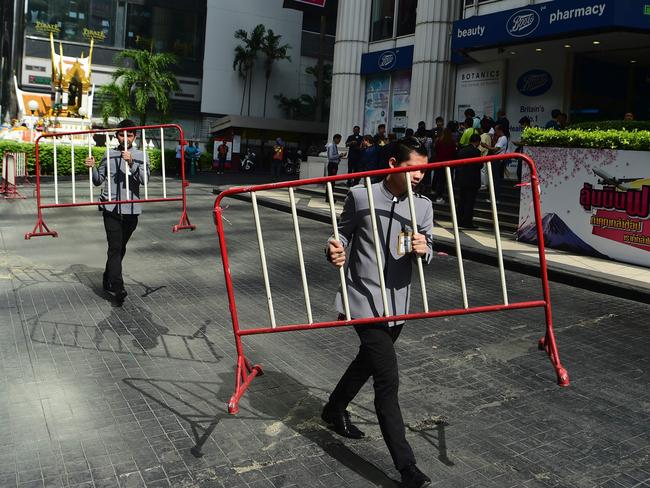 Workers carry away barricades after police disposed a suspicious bag during a false bomb scare in the tourist-heavy Ratchaprasong district of Bangkok on August 18, 2016. Picture: AFP/Munir Uz Zaman