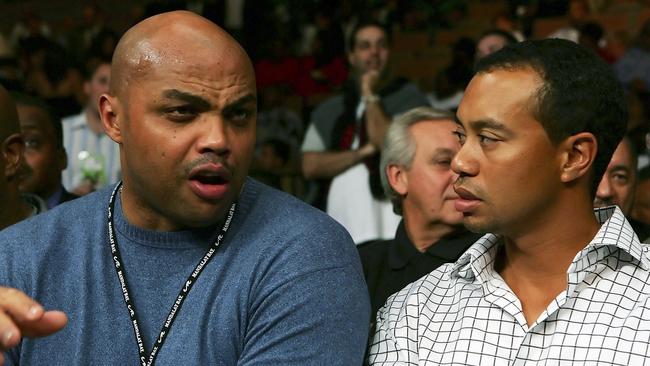 NBA great Charles Barkley chats with Tiger Woods.