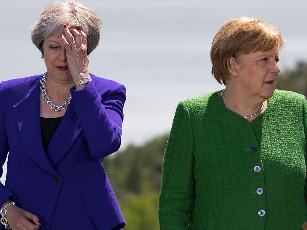 British Prime Minister Theresa May (L) stands with German Chancellor Angela Merkel (R). Picture: AFP