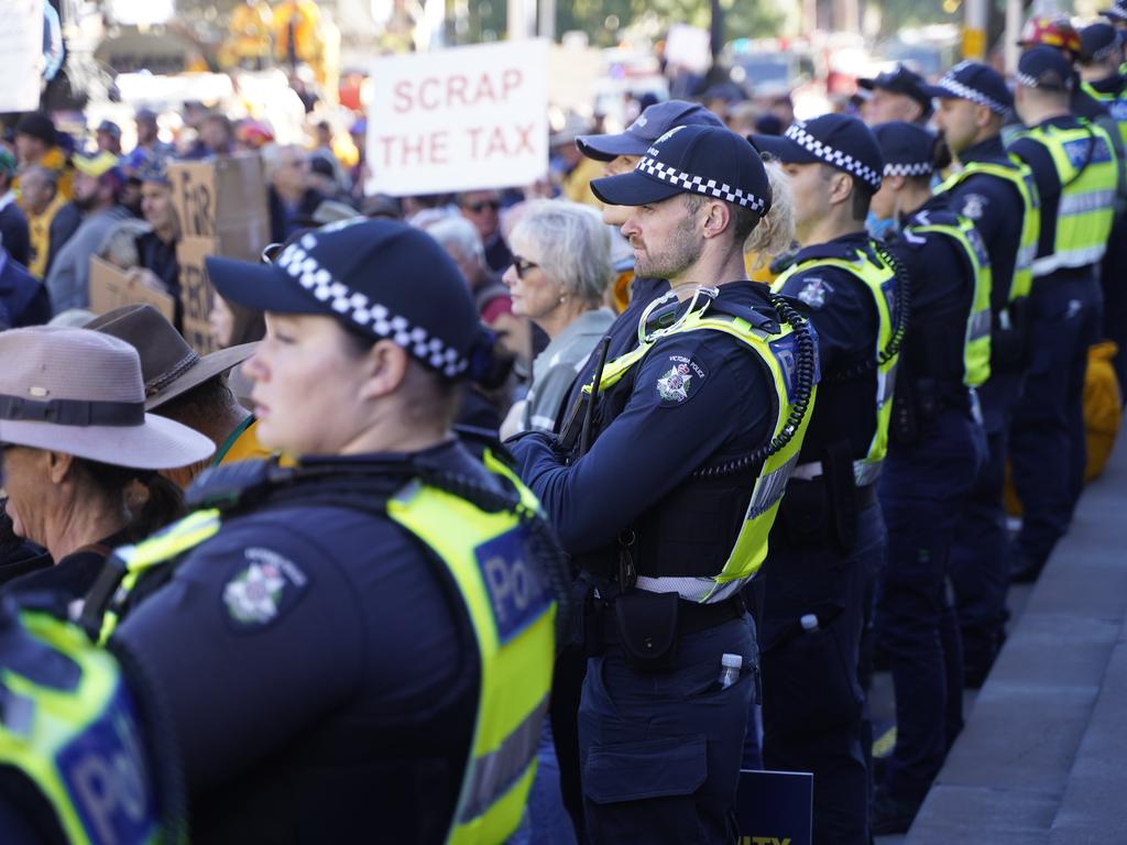 Police watched as protesters marched through the streets. Picture: NewsWire / Valeriu Campan