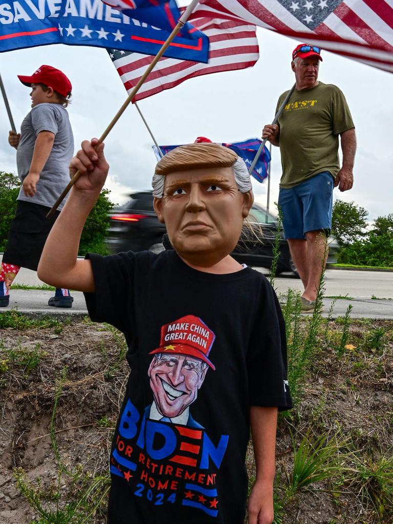 A girl wears a mask of former US President Donald Trump during a "Caravan for Trump" demonstration in West Palm Beach, Florida, on June 2. Picture: Giorgio Viera/AFP