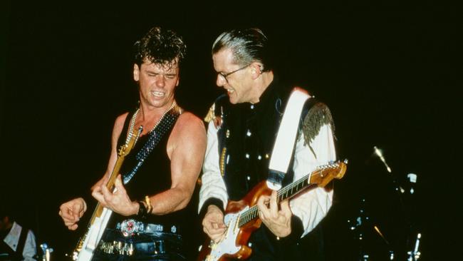 Guitarists Tim Farriss and Pengilly rocking out on the Listen Like Thieves tour. Picture: Supplied.