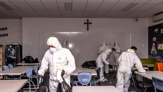 Canterbury-Bankstown Express Cleaners photographed cleaning a classroom at St Christopher's Catholic Primary in March following coronavirus fears. (AAP Image / Monique Harmer)