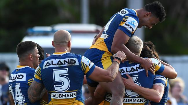 ROCKHAMPTON, AUSTRALIA - SEPTEMBER 12: Waqa Blake of the Eels jumps in his team mates as Mitchell Moses of the Eels celebrates with his team mates after scoring a try during the NRL Elimination Final match between Parramatta Eels and Newcastle Knights at Browne Park, on September 12, 2021, in Rockhampton, Australia. (Photo by Albert Perez/Getty Images)