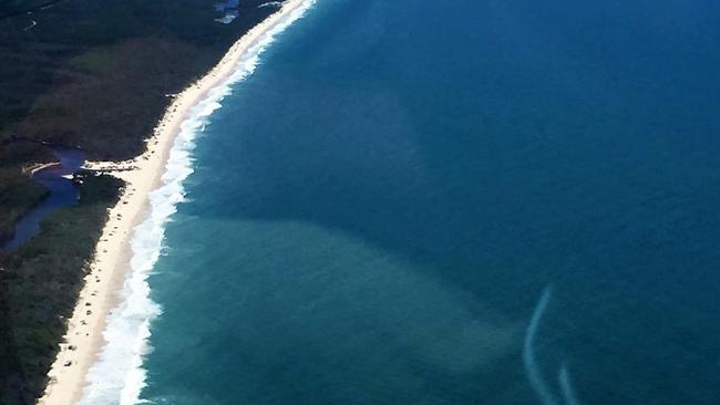 Aerial shot of Bribie's 4WD beach with a noticeable dotted line of vehicles stretching the entire length of the picture. PHOTO: My Bribie Island