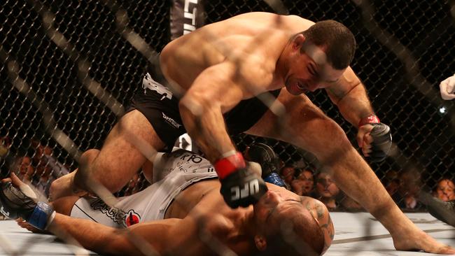 James Te Huna lies prone on the canvas as Shogun Rua lands a right hand.