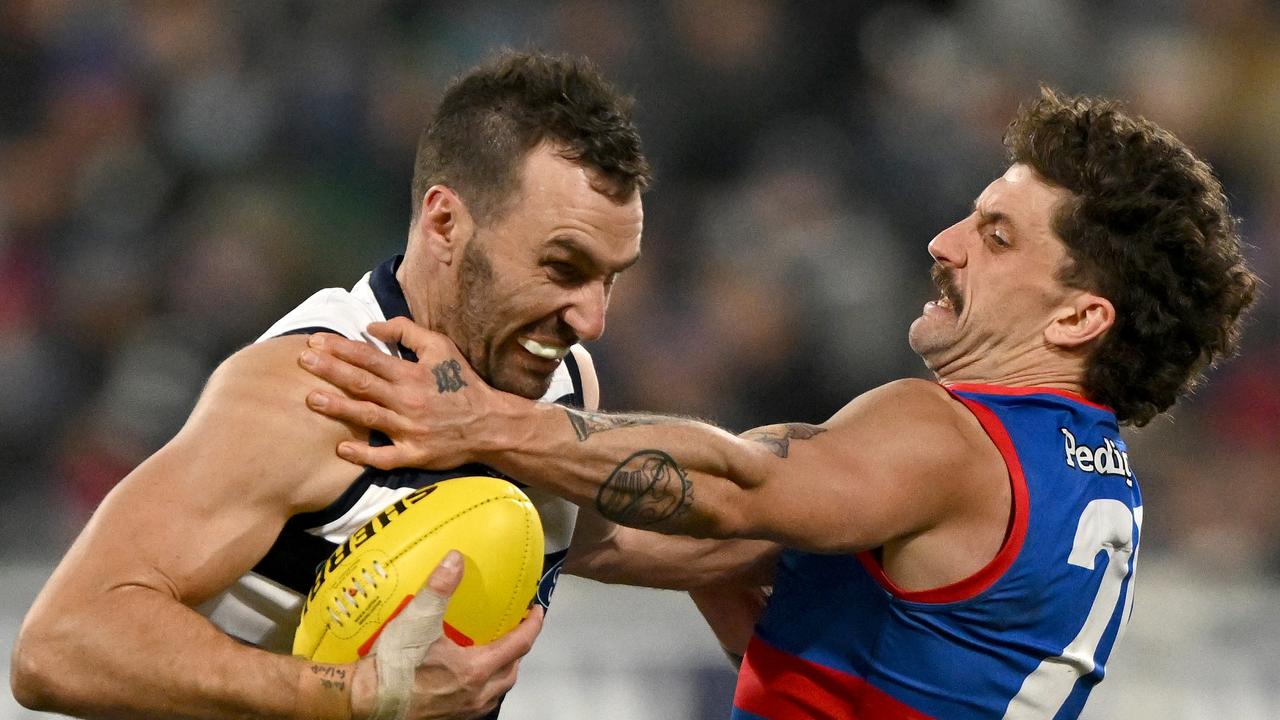 Geelong big man Jonathon Ceglar fends off Tom Liberatore. Picture: Morgan Hancock/AFL Photos