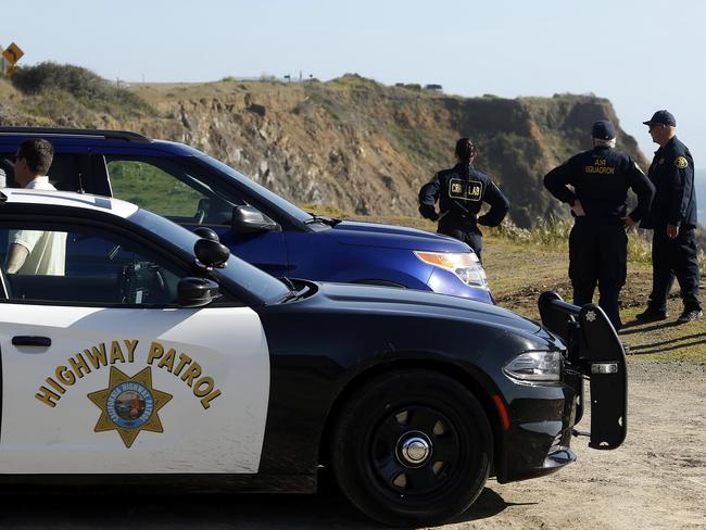 California Highway Patrol officers and deputy sheriffs from Mendocino and Alameda counties gather at the site where the bodies of Jennifer and Sarah Hart and their kids drove off a cliff. Picture: AP