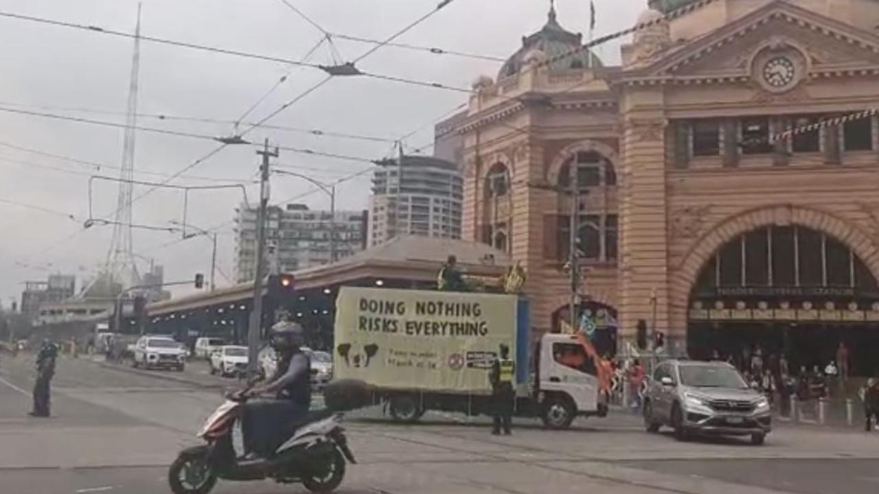 Police speak to protesters on the corner of Flinders and Swanston streets in Melbourne's CBD on March 19. Picture: Facebook