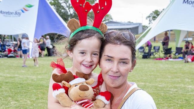 Parker and Courtney Unahi from Morayfield pose for a photograph at Caboolture Christmas Carols. (AAP Image/Richard Walker)