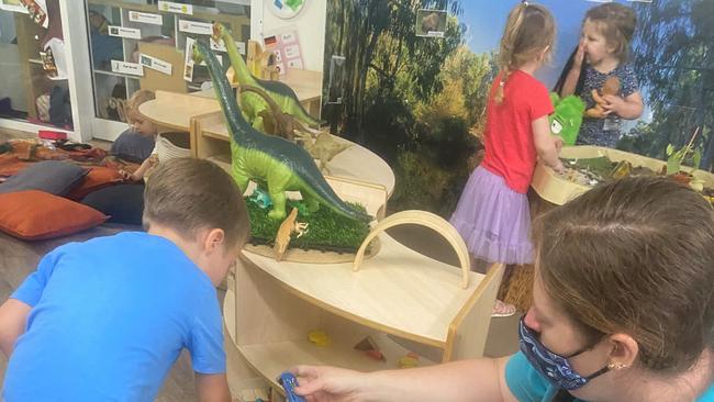 Educator Jaimi-Lee Toohey builds a racetrack with student Charlie at First Steps Early Learning in Lismore.