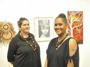 EXQUISITELY EXECUTED: Exhibition judge Bianca Beetson and art prize winner Stacie Fraser with her work  Daughter of a Warrior  in the background. Picture: Tim Jarrett