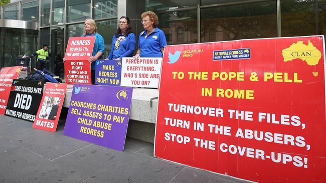 Protesters hold signs outside Melbourne County Court on March 13. Picture: Michael Dodge/Getty Images