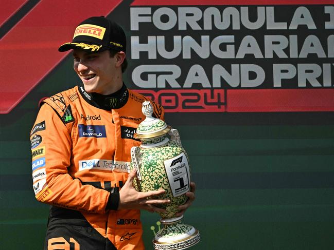 Winner Team McLaren-Mercedes' Oscar Piastri celebrates on the podium.