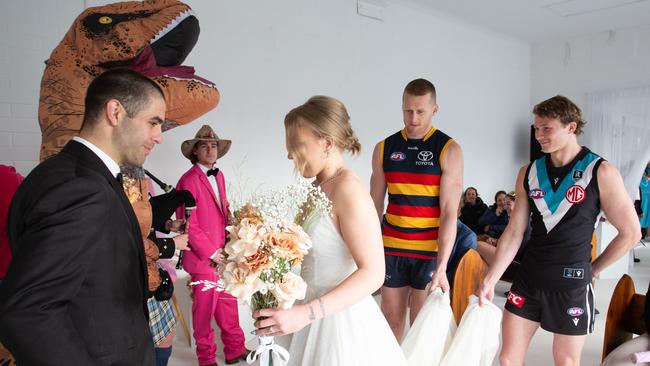 Adelaide Crows player Reilly O'Brien and Port’s Xavier Duursma help the bride down the aisle at the wedding of Dylan and Charlotte, who married on Monday morning after a one-week engagement. Picture: Brett Hartwig