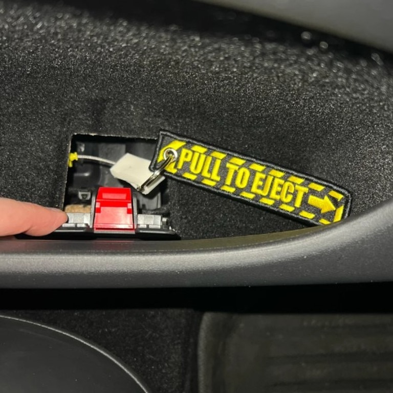 Owners are modifying their rear door emergency release to make it easier to locate. (Picture: Reddit)