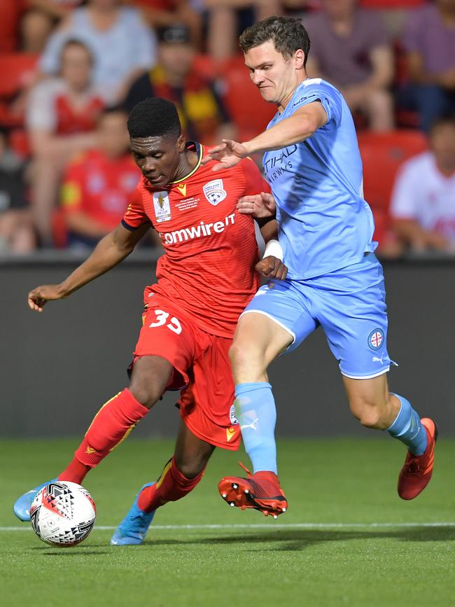 Al Hassan Toure, of Adelaide United, dribbles the ball past Curtis Good, of Melbourne City, during the FFA Cup final. Picture: Mark Brake/Getty Images