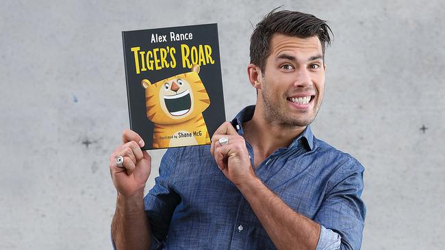 AFL Richmond footballer Alex Rance with his book. Picture: Ian Currie