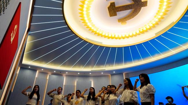 Young people recite the party's oath in front of a party flag during an exhibition at the Memorial of the First National Congress of the Communist Party of China in June. Picture: Reuters