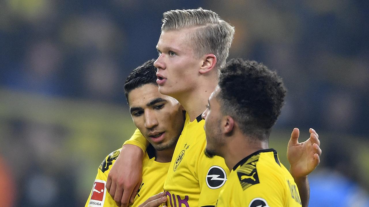 Dortmund's scorer Erling Haaland, centre, celebrates his goal with teammates Jadon Sancho, right, and Achraf Hakimi, left.