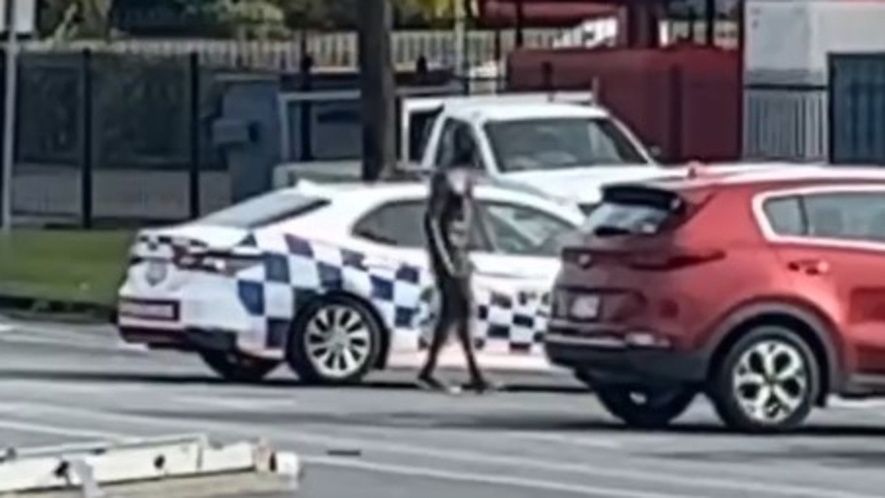 A man armed with a pole and machete has smashed the window of a car before driving off in a stolen patrol car. Picture: Supplied