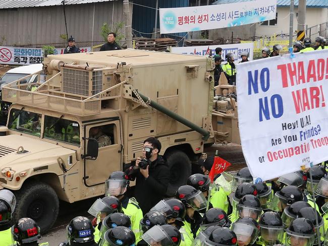 A U.S. military trailer carrying elements of the THAAD system enters a golf course in Seongju amid protests. Picture: AAP